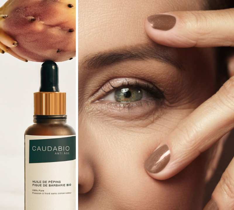 Femme montrant ses rides autour des yeux avec une bouteille d'huile de figue de barbarie Caudabio, solution naturelle anti-âge et hydratante